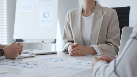 Business people team discussing financial data and analyzing charts during a productive meeting in...