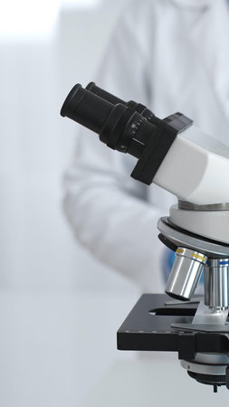Microscope is on a table, ready for innovative medical research in a sterile laboratory environment....