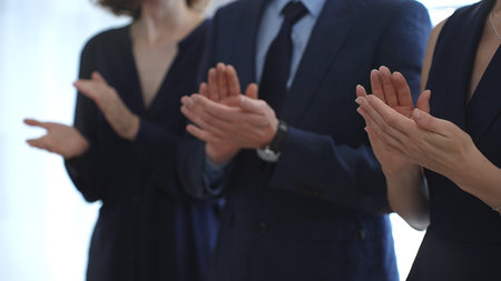 Business people are clapping hands, expressing gratitude and acknowledging a successful performance or presentation, creating a positive and encouraging atmosphere in a professional settingの写真素材