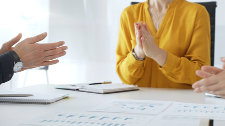 Business colleagues clapping hands after successful presentation or good news during a corporate...