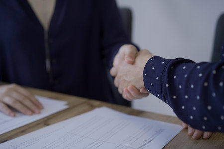 Accountants or auditors shaking hands after reviewing financialの写真素材