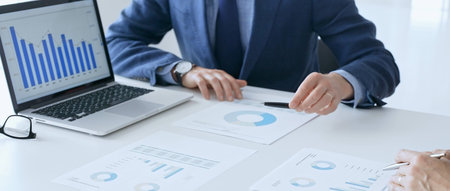 Business team of diverse colleagues are reviewing financial data, analyzing charts and graphs,...