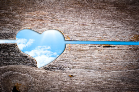 Wooden door , heart shape and blue skyの写真素材