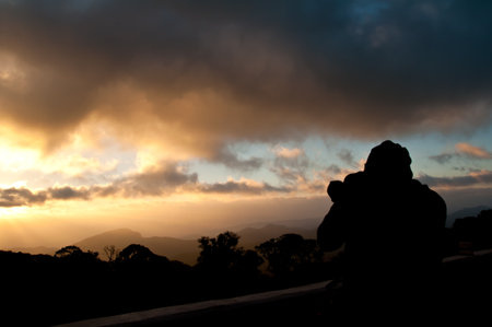 silhouette of photographer shooting sunset on the mountain  の写真素材