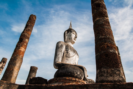 Buddha Statue in Wat Mahathat Temple in Sukhothai Historical park at sunrise, Thailand 