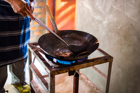 The chef is stirring the food.の写真素材