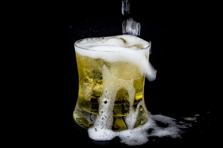 Glass and ice with whiskey on black background.の写真素材