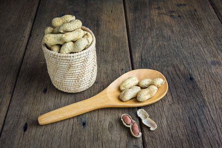 Peanuts are placed on old wooden floor.の写真素材