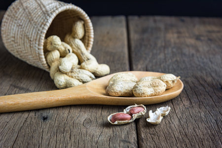 Peanuts are placed on old wooden floor.の写真素材