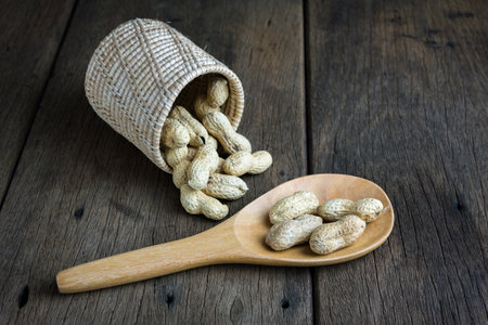 Peanuts are placed on old wooden floor.の写真素材