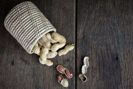 Peanuts are placed on old wooden floor.の写真素材