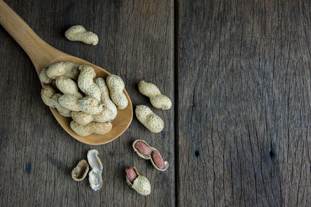 Peanuts are placed on old wooden floor.の写真素材