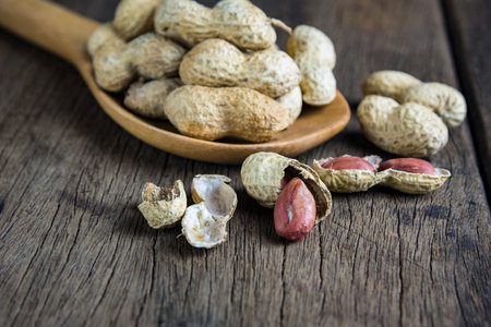 Peanuts are placed on old wooden floor.の写真素材