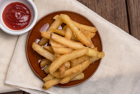 The french fries are placed in a cup with ketchup.の写真素材