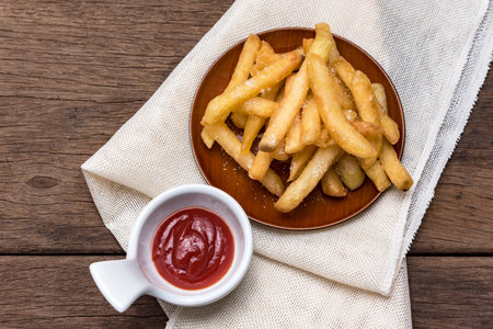 The french fries are placed in a cup with ketchup.の写真素材