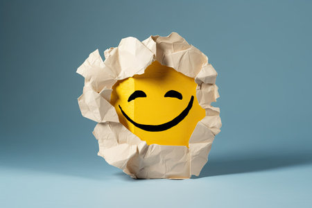 Smiling happy face under a torn paper, positive emotions, good customer feedback, laughingの素材