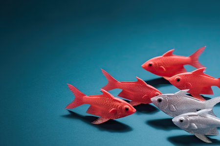 Red fish is the leader of the group, leadership and teamwork concept, be a winner, success and start up in business, follow a new ideaの素材