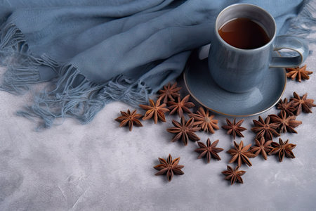 Coffee with star anise on a blue scarf and on a grey structured backgroundの素材