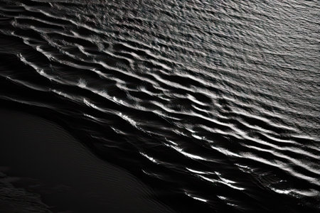 black abstract background black and white background the rippling surface of the water in the sunlight view of the large river and the coastline from the mountain top view monochromeの素材