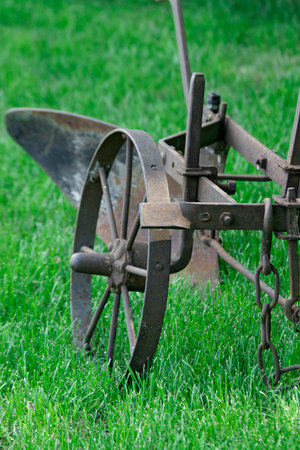 An old equestrian plow on green grass. The middle band of Russia.  Very rare ancient plow.の写真素材