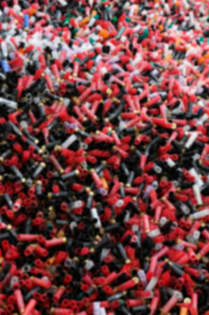 Blurred abstract background of sport cartridges. Sports shooting on skeet.  A mountain of cartridges...