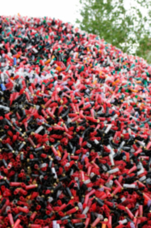 Blurred abstract background of sport cartridges. Sports shooting on skeet.  A mountain of cartridges...