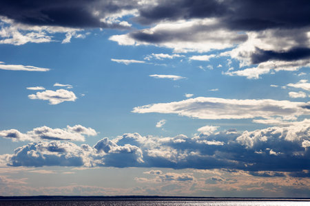 Clouds over the river. Terrible over the leaden water.の写真素材