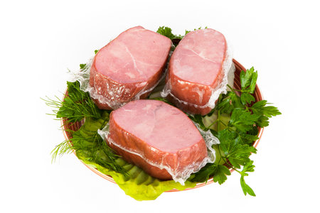 Smoked pork neck with greens laid on a platter.の写真素材