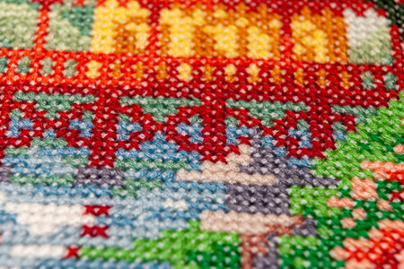 Cross-stitch. Macro photography of embroidery sites. Shooting with a small bluff of sharpness. Bright patterns on the canvas.の写真素材
