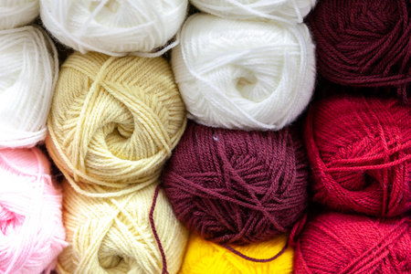 Store shelf with color yarn for knitting with needles, crochet hook. Bright ball of cotton and synthetic yarn.の写真素材