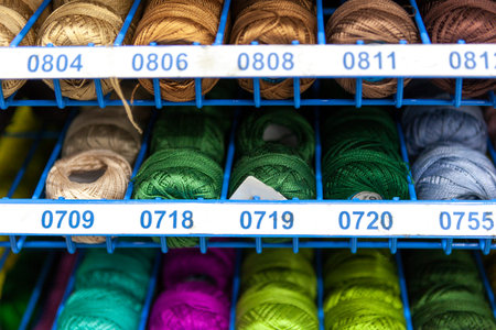 Rocks with colorful stitching for clother, sewing and darning. Background. Colorful nylon and...