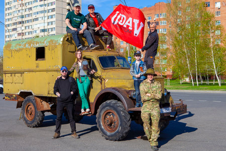 TOLYATTI, RUSSIA, MAY 09, 2018: holiday didicated to Victory day. Green truck kamaz made on GAZ with people. Vintage car.のeditorial素材
