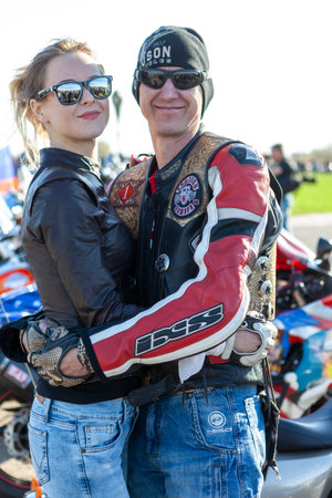 TOLYATTI, RUSSIA, MAY 09, 2018: SHOW OF BIKERS DEDICATED TO VICTORY DAY. HUGGING MAN AND WOMAN BIKERS.のeditorial素材