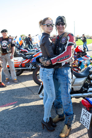 TOLYATTI, RUSSIA, MAY 09, 2018: SHOW OF BIKERS DEDICATED TO VICTORY DAY. HUGGING MAN AND WOMAN BIKERS.のeditorial素材