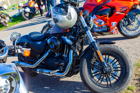 TOLYATTI, RUSSIA, MAY 09, 2018: Biker show dedicated to Victory Day. Black matte motorcycle with helmet on handle and chrome pipes.のeditorial素材