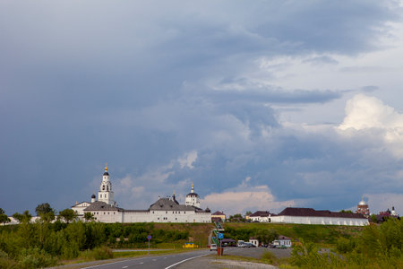 Cloudy sky over island city Sviyazhsk. Historical island-hail. White wall building. Dark gray sky.のeditorial素材