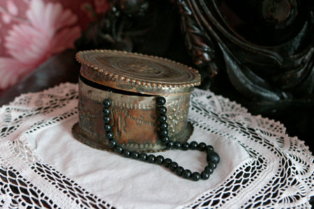 izran, Russia, February 10, 2005: Museum, interior of the merchant's living room. Copper jewelry box with black beads on a knitted napkin. Carved wooden dressing table. Retro style room.のeditorial素材