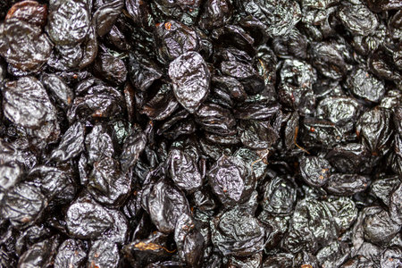 Prune texture in shop close up. Large pile of prunes, dried fruits, healthy dessert, vegetarian food.の写真素材