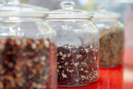 Tea blends in glass jars on the counter of the cafe.の写真素材