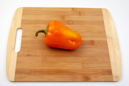Fresh red bell pepper on bamboo cutting board.  Red bright taste.の写真素材