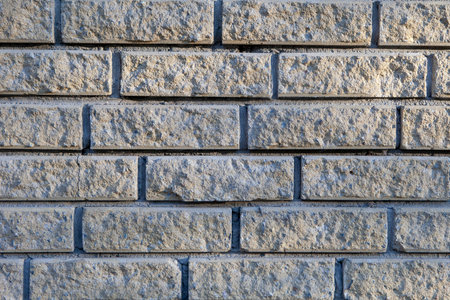 Brick wall of light background in the rays of the sun.の写真素材