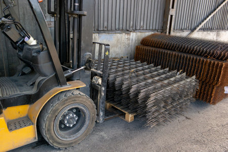 forklift carrying a stack of rebar mesh