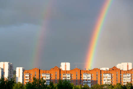 A rainbow appeared over the houses After the rainの写真素材