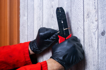 electrician installs an electric light switch on the wallの写真素材