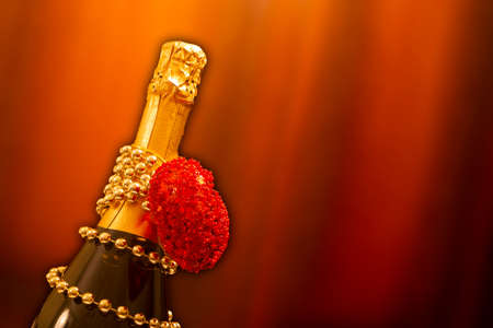 a holiday card.a bottle of champagne on a brown background. Copyspaceの写真素材
