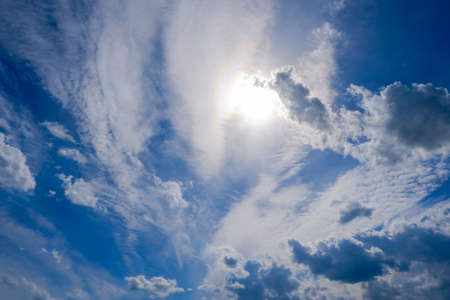 the sun shines through the clouds in sunny summer weather,の写真素材