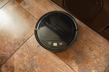 the robot vacuum cleaner vacuums the floor in the apartment.の写真素材