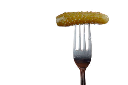 pickled cucumber on a fork isolated on a white backgroundの写真素材