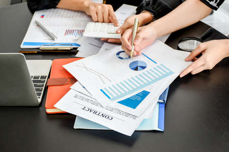 Top view of Businesswoman and partner examining or analyzing resume documents on desk at the office.の写真素材