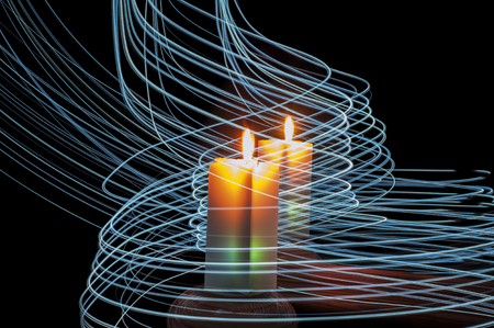 Coloful candle, it's reflection in a mirror and many blue stripes of light around them, performed in a light painting technique, on black backgroundの写真素材